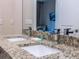 Bathroom boasts a double sink with granite countertops, offering ample space and luxury at 7672 Amazonas St, Kissimmee, FL 34747