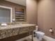 Bathroom with granite vanity, white fixtures, and modern design at 7672 Amazonas St, Kissimmee, FL 34747