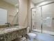 Modern bathroom featuring a bathtub, shower, and granite countertop at 7672 Amazonas St, Kissimmee, FL 34747