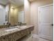 Bathroom featuring a granite countertop and double sink, offering both style and functionality at 7672 Amazonas St, Kissimmee, FL 34747
