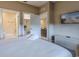 Cozy bedroom with a TV, a dresser, and access to a closet and ensuite bathroom provides comfort and convenience at 7672 Amazonas St, Kissimmee, FL 34747