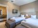 Cozy bedroom featuring two twin beds, soft bedding, and en-suite bathroom access at 7672 Amazonas St, Kissimmee, FL 34747
