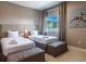 Bright bedroom with two twin beds and seating, offering a comfortable and inviting space for relaxation at 7672 Amazonas St, Kissimmee, FL 34747