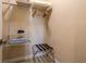 Organized closet with shelving, clothes hangers, and luggage rack at 7672 Amazonas St, Kissimmee, FL 34747