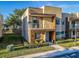 Modern two-story home with a stone accent wall and balcony at 7672 Amazonas St, Kissimmee, FL 34747