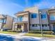 Modern townhome with balcony, stone accents, and well-maintained landscaping at 7672 Amazonas St, Kissimmee, FL 34747
