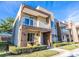 Modern townhome with balcony, stone accents, and well-maintained landscaping at 7672 Amazonas St, Kissimmee, FL 34747