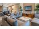 Open concept living room with stylish furniture, modern TV, and view of kitchen at 7672 Amazonas St, Kissimmee, FL 34747