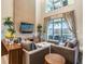 Living room featuring high ceilings, neutral furnishings, and sliding glass doors at 7672 Amazonas St, Kissimmee, FL 34747