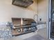 Well-equipped outdoor grill with stainless steel appliances and granite countertop at 7672 Amazonas St, Kissimmee, FL 34747