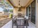Covered outdoor kitchen with built-in grill and dining table overlooking the backyard at 7672 Amazonas St, Kissimmee, FL 34747
