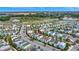 Community aerial view with colorful houses, illustrating the layout and access to the main road and green spaces at 8044 Lost Shaker Ln, Kissimmee, FL 34747