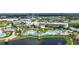 Resort style living featuring a large pool, lush landscaping, and access to a picturesque lake at 8044 Lost Shaker Ln, Kissimmee, FL 34747