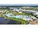 Luxury resort aerial view highlighting the large pools, multiple buildings, and landscaping near a tranquil lake at 8044 Lost Shaker Ln, Kissimmee, FL 34747