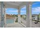 Balcony with white columns and railings overlooking neighborhood houses at 8044 Lost Shaker Ln, Kissimmee, FL 34747