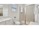 Clean bathroom with a glass-enclosed shower and a window at 8044 Lost Shaker Ln, Kissimmee, FL 34747