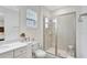 Well-lit bathroom featuring glass-enclosed shower, updated vanity, and tile flooring at 8044 Lost Shaker Ln, Kissimmee, FL 34747