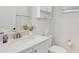 Clean half bathroom with white fixtures, granite countertop, and decorative mirror at 8044 Lost Shaker Ln, Kissimmee, FL 34747