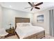 Comfortable bedroom with ceiling fan, wooden bed frame, and tranquil decor at 8044 Lost Shaker Ln, Kissimmee, FL 34747