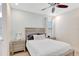 Cozy bedroom featuring a ceiling fan and decorative pillows on a comfortable bed with side tables at 8044 Lost Shaker Ln, Kissimmee, FL 34747