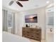 Bedroom featuring a ceiling fan, mounted TV, and wooden dresser at 8044 Lost Shaker Ln, Kissimmee, FL 34747
