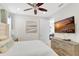Bedroom featuring a ceiling fan, mounted TV, and a bed with decorative pillows at 8044 Lost Shaker Ln, Kissimmee, FL 34747