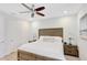 Comfortable bedroom with ceiling fan, wooden bed frame, and tranquil decor at 8044 Lost Shaker Ln, Kissimmee, FL 34747
