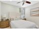 Bright bedroom featuring a queen bed, two side tables, and a light color palette at 8044 Lost Shaker Ln, Kissimmee, FL 34747