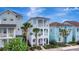 Inviting three-story home with double balconies, complemented by palm trees and colorful neighbors at 8044 Lost Shaker Ln, Kissimmee, FL 34747