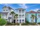 Charming three-story home with double balconies and lush tropical landscaping at 8044 Lost Shaker Ln, Kissimmee, FL 34747