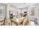 Modern kitchen and dining area featuring stainless steel appliances, ample lighting, and a spacious table at 8044 Lost Shaker Ln, Kissimmee, FL 34747