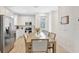 Bright kitchen and dining area with stainless steel appliances and white cabinetry at 8044 Lost Shaker Ln, Kissimmee, FL 34747