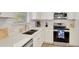 Well-lit kitchen featuring stainless steel appliances, white cabinetry, and granite countertops at 8044 Lost Shaker Ln, Kissimmee, FL 34747