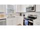 Stylish kitchen with white cabinets, stainless steel appliances, and quartz countertops at 8044 Lost Shaker Ln, Kissimmee, FL 34747