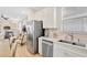 Open concept kitchen with stainless steel appliances adjacent to the living area at 8044 Lost Shaker Ln, Kissimmee, FL 34747