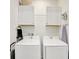 Bright laundry room equipped with washer, dryer, and ample storage at 8044 Lost Shaker Ln, Kissimmee, FL 34747