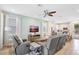 Spacious living room with stylish furniture, large TV, and an open layout to the adjacent dining area at 8044 Lost Shaker Ln, Kissimmee, FL 34747