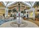 Grand lobby with a soaring ceiling, tropical plants, a decorative compass, and stylish seating arrangements at 8044 Lost Shaker Ln, Kissimmee, FL 34747