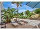 Patio featuring chaise lounges, lush landscaping, and an umbrella for shade at 8044 Lost Shaker Ln, Kissimmee, FL 34747