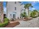 Charming patio area featuring a table, chairs, grill, and lounge chairs surrounded by lush landscaping and tropical trees at 8044 Lost Shaker Ln, Kissimmee, FL 34747