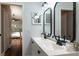 Bathroom featuring double sinks, modern fixtures, and a view into the main bedroom at 830 Grand Hughey Ct, Apopka, FL 32712