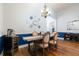 Open dining space featuring hardwood floors, adjacent to a wine refrigerator at 830 Grand Hughey Ct, Apopka, FL 32712