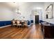 Open-concept dining area with dark wood floors adjacent to the main entrance at 830 Grand Hughey Ct, Apopka, FL 32712