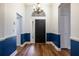 Bright foyer with wood floors, neutral wall paint, and a decorative chandelier above the front door at 830 Grand Hughey Ct, Apopka, FL 32712