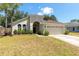 Charming single-story home featuring a manicured lawn and an attached two-car garage at 830 Grand Hughey Ct, Apopka, FL 32712