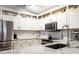 Bright kitchen features stainless steel appliances, subway tile backsplash, and ample counter space at 830 Grand Hughey Ct, Apopka, FL 32712