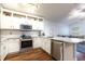 Well-lit kitchen with stainless steel appliances, center island, and open layout at 830 Grand Hughey Ct, Apopka, FL 32712