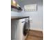 Laundry room with a front load washer and dryer and custom countertops at 830 Grand Hughey Ct, Apopka, FL 32712