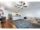 Open-concept living space with kitchen, featuring hardwood floors and comfortable seating at 830 Grand Hughey Ct, Apopka, FL 32712
