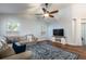 Bright living room with vaulted ceilings, ceiling fan, and neutral color palette at 830 Grand Hughey Ct, Apopka, FL 32712